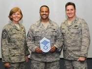 KADENA AIR BASE, Japan -- Master Sgt. Shawn Gilmore (center) poses for a photo with Col. John Glaze (right), the 353rd Special Operations Group deputy commander, and Chief Master Sgt. Vicki Gamble, the 353rd SOG command chief master sergeant, after being selected for promotion to senior master sergeant here March 5. (U.S. Air Force photo by Tech. Sgt. Aaron Cram)
