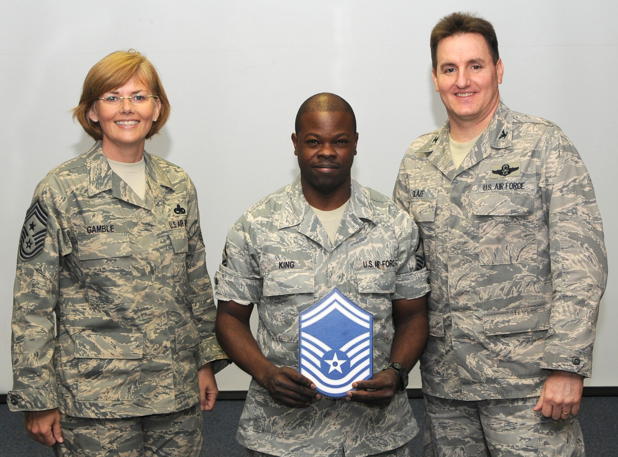 KADENA AIR BASE, Japan -- Master Sgt. Richard King (center) poses for a photo with Col. John Glaze (right), the 353rd Special Operations Group deputy commander, and Chief Master Sgt. Vicki Gamble, the 353rd SOG command chief master sergeant, after being selected for promotion to senior master sergeant here March 5. (U.S. Air Force photo by Tech. Sgt. Aaron Cram)