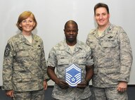 KADENA AIR BASE, Japan -- Master Sgt. Richard King (center) poses for a photo with Col. John Glaze (right), the 353rd Special Operations Group deputy commander, and Chief Master Sgt. Vicki Gamble, the 353rd SOG command chief master sergeant, after being selected for promotion to senior master sergeant here March 5. (U.S. Air Force photo by Tech. Sgt. Aaron Cram)