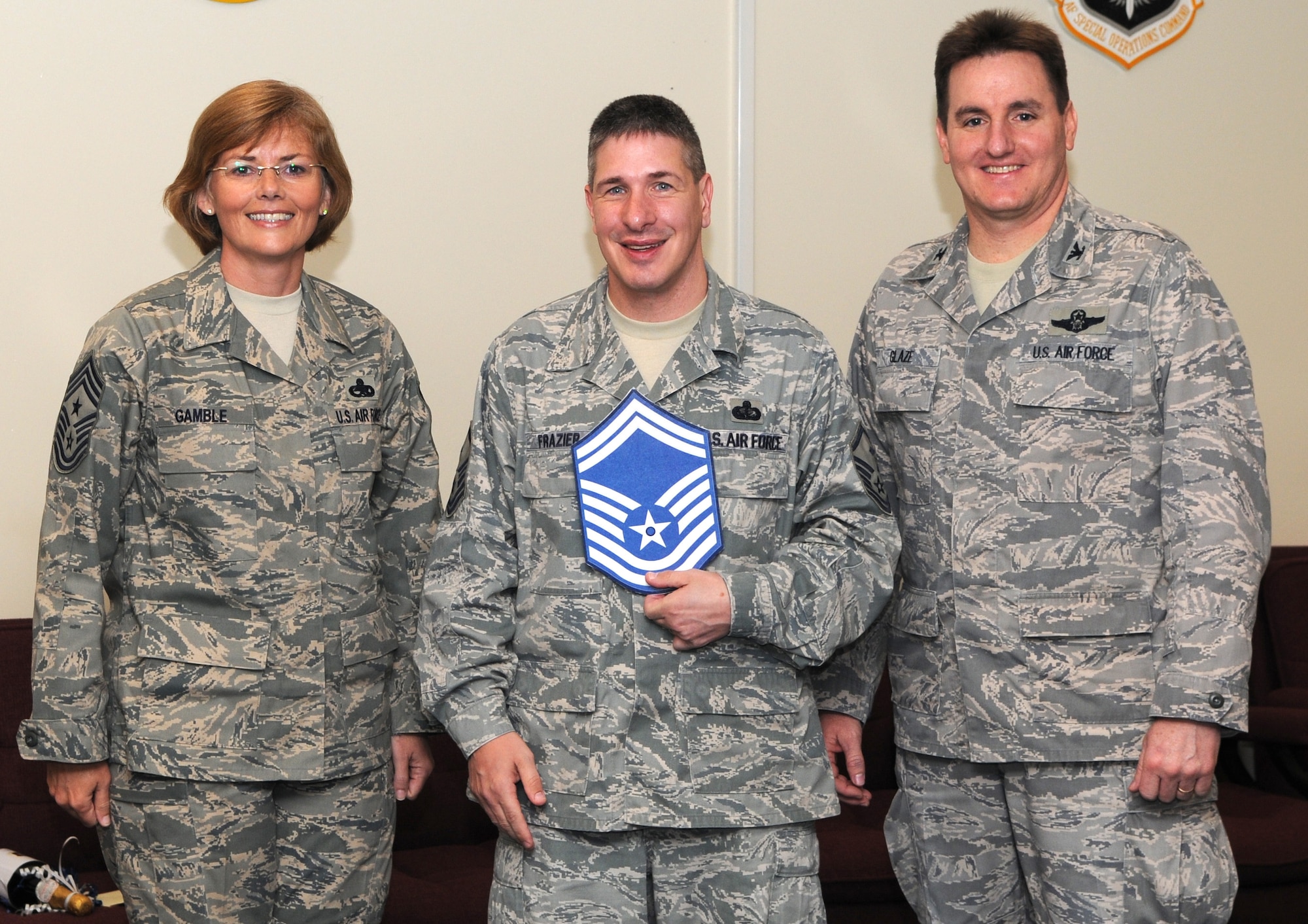KADENA AIR BASE, Japan -- Master Sgt. Michael Frazier (center) poses for a photo with Col. John Glaze (right), the 353rd Special Operations Group deputy commander, and Chief Master Sgt. Vicki Gamble, the 353rd SOG command chief master sergeant, after being selected for promotion to senior master sergeant here March 5. (U.S. Air Force photo by Tech. Sgt. Aaron Cram)