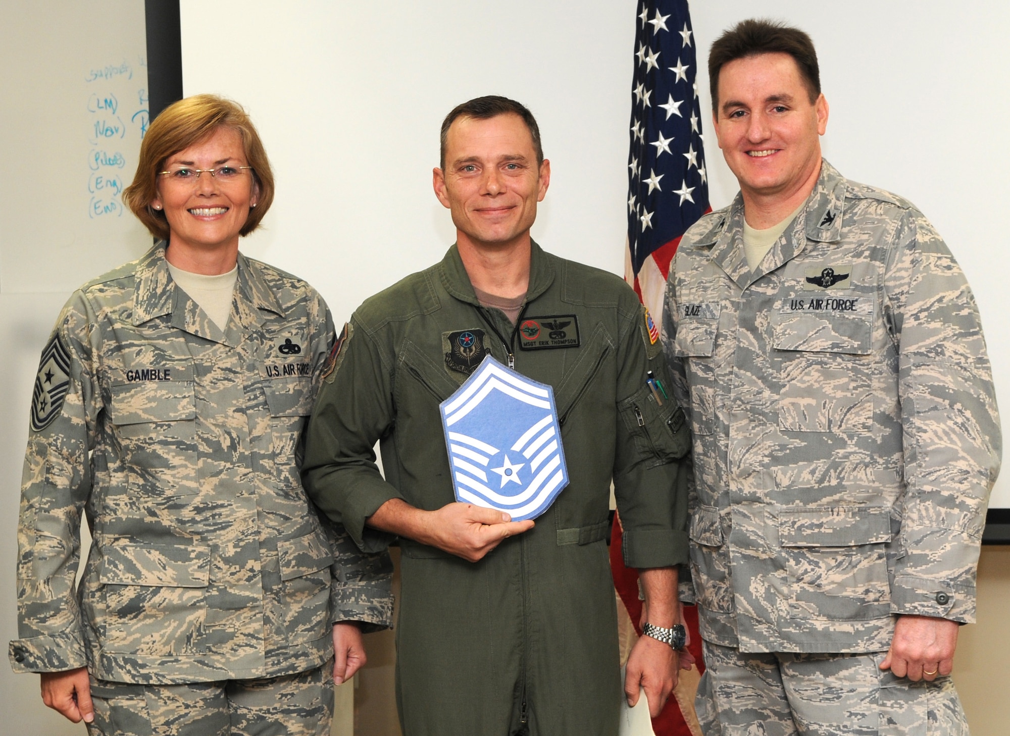 KADENA AIR BASE, Japan -- Master Sgt. Erik Thompson (center) poses for a photo with Col. John Glaze (right), the 353rd Special Operations Group deputy commander, and Chief Master Sgt. Vicki Gamble, the 353rd SOG command chief master sergeant, after being selected for promotion to senior master sergeant here March 5. (U.S. Air Force photo by Tech. Sgt. Aaron Cram)