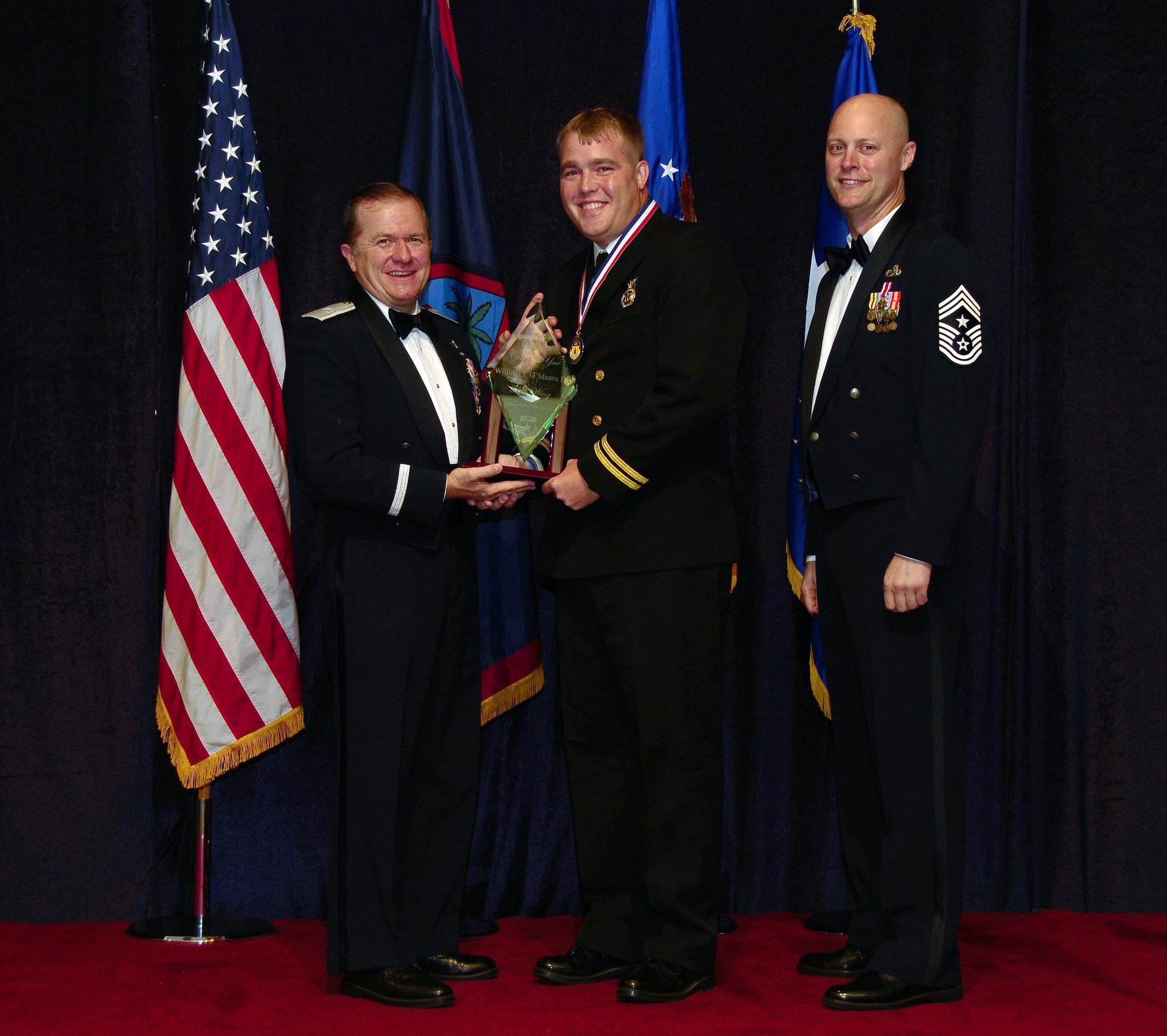 ANDERSEN AIR FORCE BASE, Guam - Civilian of the Year (Category 2) winner William O'Meara Jr; 36th Mission Support Group, is congratulated by Brig. Gen. Phil Ruhlman, Commander, 36th Wing, and Command Chief Master Sgt. Allen Mullinex during the Feb. 19 Annual Award ceremony.( U.S. Air Force photo by Airman 1st Class Jeffrey Schultze)