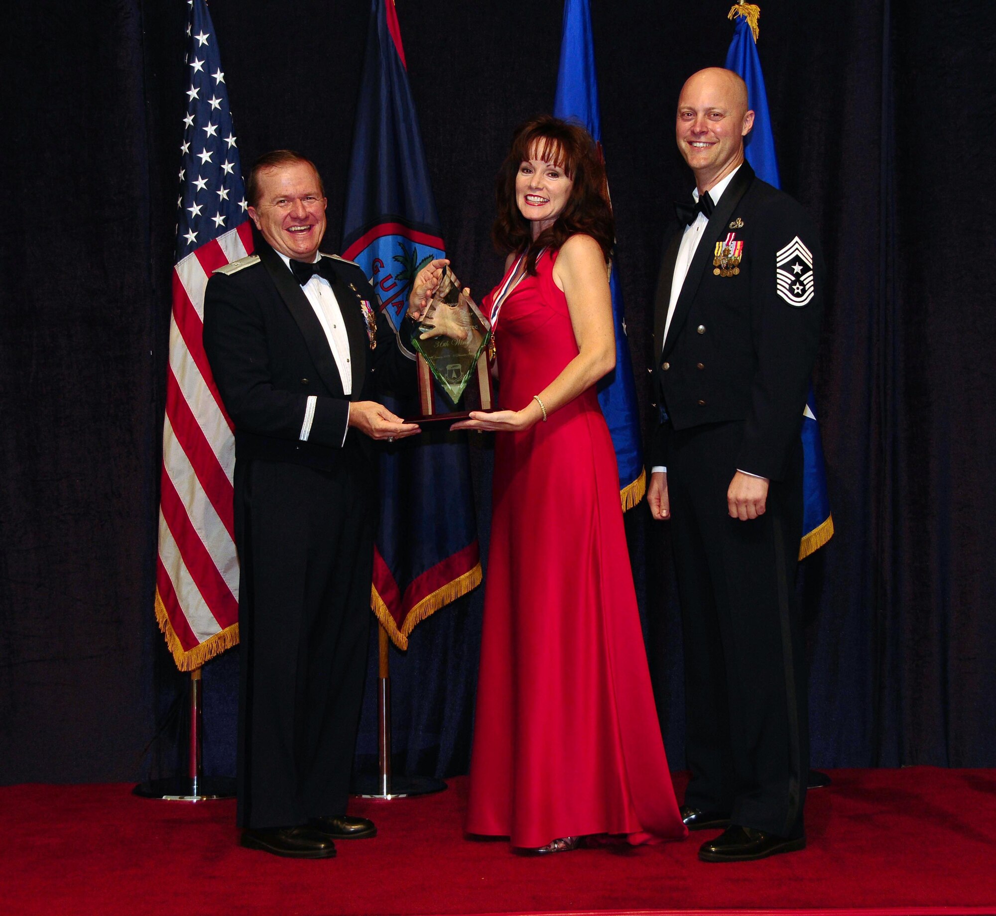 ANDERSEN AIR FORCE BASE, Guam - Civilian of the Year (Category 1) winnerJennifer Andree, 36th Medical Group, is congratulated by Brig. Gen. Phil Ruhlman, Commander, 36th Wing, and Command Chief Master Sgt. Allen Mullinex during the Feb. 19 Annual Award ceremony.( U.S. Air Force photo by Airman 1st Class Jeffrey Schultze)