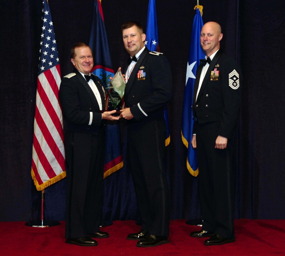 Company Grade Officer (CGO) of the Year winner Captain Jason M. Aftanas, 554 Red Horse Squadron, is congratulated by Brig. Gen. Phil Ruhlman, Commander, 36th Wing, and Command Chief Master Sgt. Allen Mullinex during the Feb. 19 Annual Award ceremony. The CGO of the Year was one of the many awards given out that night ( U.S. Air Force photo by Airman 1st Class Jeffrey Schultze)