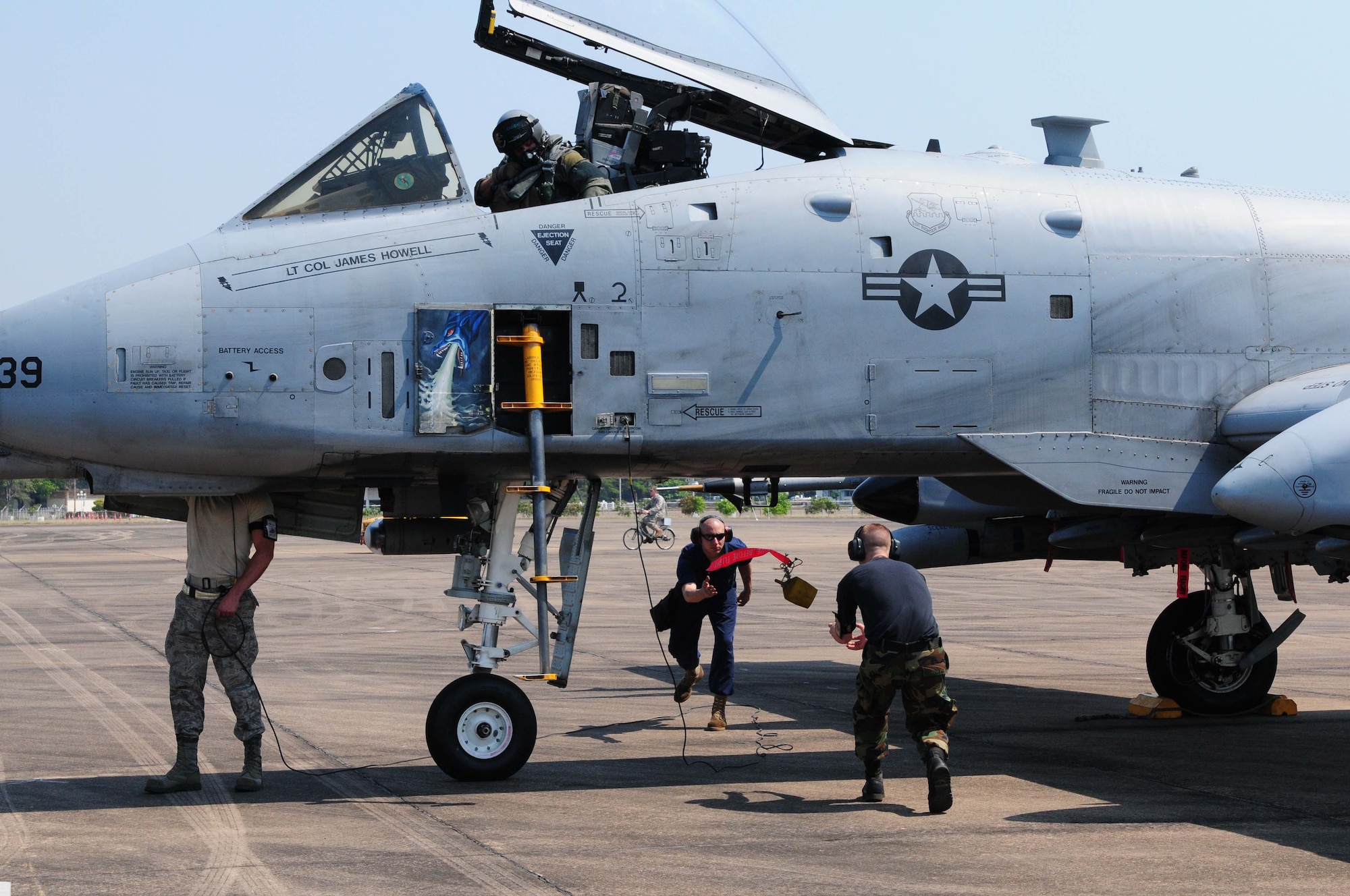 Airmen from the 25th Aircraft Maintenance Unit at Osan Air Base, South Korea, discard the “remove before flight” streamers prior to an A-10 Thunderbolt II take-off at Udon Thani Royal Thai Air Force Base, Thailand, on March 4. The Airmen are participating in the annual, multilateral field training exercise involving the U.S. Air Force, Royal Thai Air Force and Army, and the Republic of Singapore Air Force March 1-12.  (U.S. Air Force photo/Capt. Genieve David)