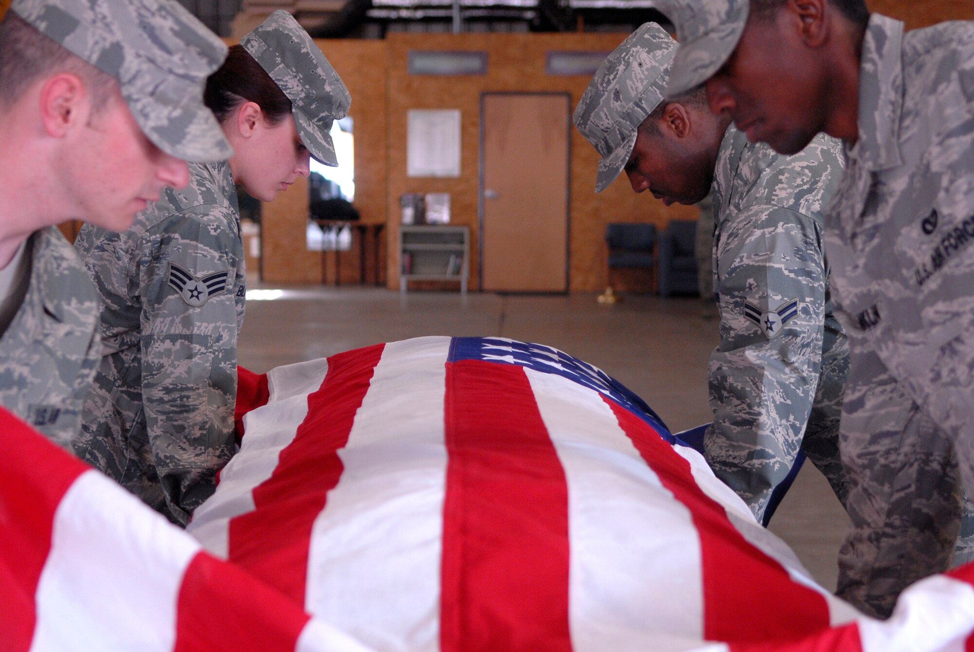 VANDENBERG AIR FORCE BASE, Calif. -- Vandenberg Honor Guard trainers perform pallbearer duties during training week at the base honor guard facility here Wednesday, March 3, 2010.  During the ceremonial guardsmen training week, the trainees are taught teamwork, drill and rifle movements, and other Air Force ceremonial details.  (U.S. Air Force photo/Senior Airman Andrew Satran) 


 
 