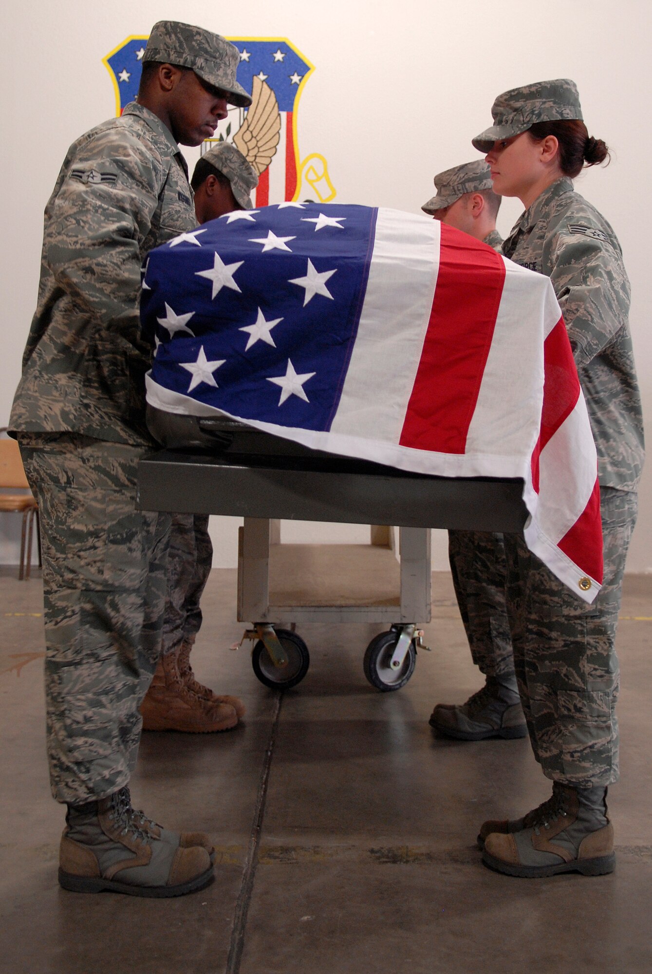 VANDENBERG AIR FORCE BASE, Calif. -- Vandenberg Honor Guard trainers perform pallbearer duties during training week at the base honor guard facility here Wednesday, March 3, 2010.  During the ceremonial guardsmen training week, the trainees are taught teamwork, drill and rifle movements, and other Air Force ceremonial details.  (U.S. Air Force photo/Senior Airman Andrew Satran) 


 
 