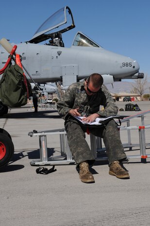 NELLIS AIR FORCE BASE, Nev. -- Senior Airman Kevin Henry, an A-10 Crew Chief with the 81st Aircraft Maintenance Unit (AMU),prepares forms for the first flight of the day during Red Flag 10-3 here March 3, 2010. Red Flag is a realistic combat training exercise involving the air forces of the United States and its allies. The exercise is conducted on the 15,000-square-mile Nevada Test and Training Range, north of Las Vegas. (U.S Air Force photo by Staff Sgt. Taylor Worley/RELEASED)