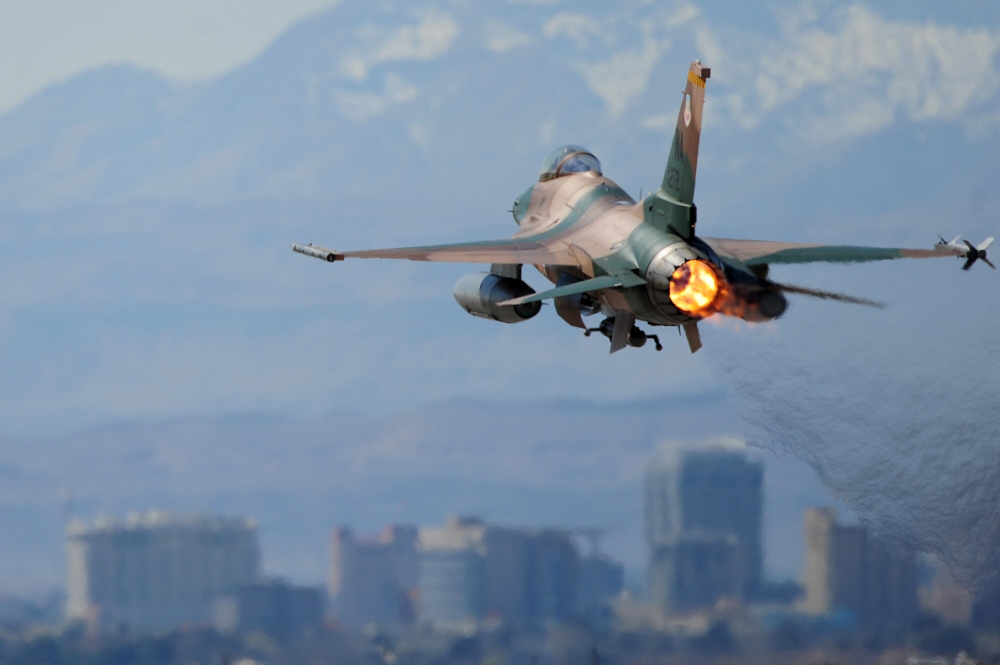 NELLIS AIR FORCE BASE, NEV. -- 
An F-16 Aggressor takes off from the Nellis flight line during a Red Flag Exercise, March 3, 2010. Red Flag is a realistic combat training exercise involving the air forces of the United States and its allies. The exercise is conducted on the 15,000-square-mile Nevada Test and Training Range, north of Las Vegas.   (U.S. Air Force Photo by Staff Sgt. William P. Coleman/RELEASED)
