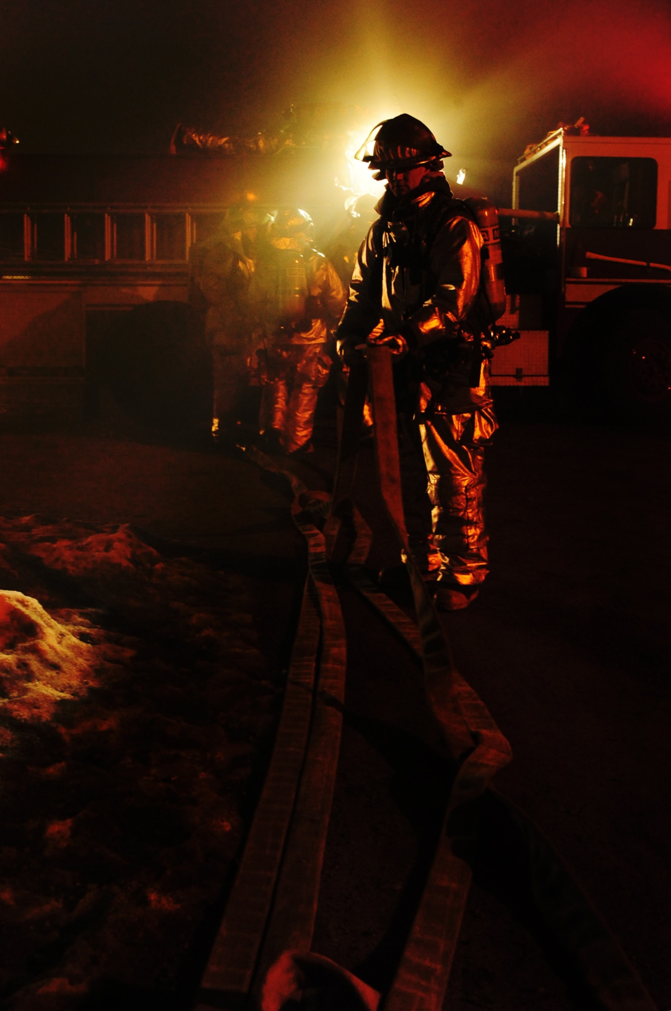 ELLSWORTH AIR FORCE BASE, S.D. -- Senior Airman Cody Simpson, 28th Civil Engineer Squadron firefighter, organizes hoses after responding to a simulated building fire during a Phase II Operational Readiness Exercise, March 3. The Phase II ORE is designed to simulate a deployed environment and test the combat abilities of Ellsworth Airmen. (U.S. Air Force photo/Airman 1st Class Joshua J. Seybert)