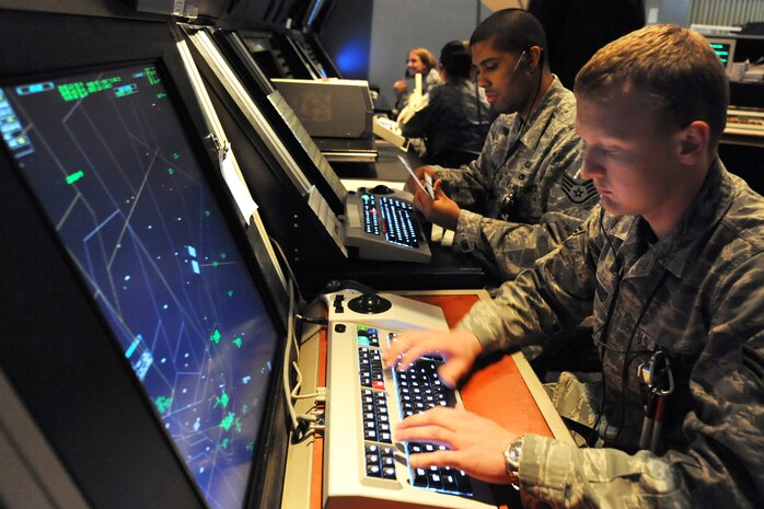 NELLIS AIR FORCE BASE, Nev. Airman 1st Class Joseph Howard, air traffic control apprentice, 57th Operations Support Squadron, inputs  aircraft flight information into the micro-enroute tracking system as Staff Sgt. Jason Medina reviews flight plan information during Red Flag 10-3 on Feb 26, 2010.   Both controllers ensure the safety of aircraft departing and recovering from the 15,000-square-mile Nevada Test and Training Range, north of Nellis Air Force Base. (U.S. Air Force photo by Lawrence Crespo/RELEASED)