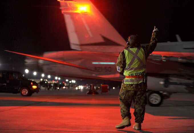 NELLIS AIR FORCE BASE, Nev. -- Cpl. Mathew Stanford, crew chief assigned to the 77th Aircraft Maintenance Squadron, Royal Australian Air Force, gives a 'thumbs up' to a  F-18 assigned to the 77th Fighter Squadron, RAAF, that taxi's out for a training mission at Red Flag 10-3 Feb. 25, 2010.  Red Flag is a realistic combat training exercise involving the air forces of the United States and its allies. The exercise is conducted on the 15,000-square-mile Nevada Test and Training Range, north of Las Vegas. (U.S. Air Force photo by Airman 1st Class Brett Clashman/RELEASED)