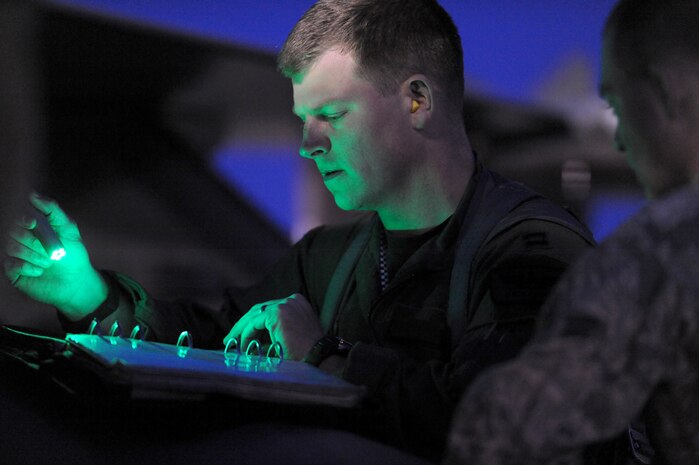 NELLIS AIR FORCE BASE, Nev. -- Capt. Mathew Russell an F-16 Pilot assigned to the 55th Fighter Squadron, Shaw AFB S.C.   goes over pre-flight paperwork before a night mission at Red Flag 10-3 Feb 25, 2010.  Red Flag is a realistic combat training exercise involving the air forces of the United States and its allies. The exercise is conducted on the 15,000-square-mile Nevada Test and Training Range, north of Las Vegas.  (U.S. Air Force photo by Tech. Sgt. Michael R. Holzworth/RELEASED)