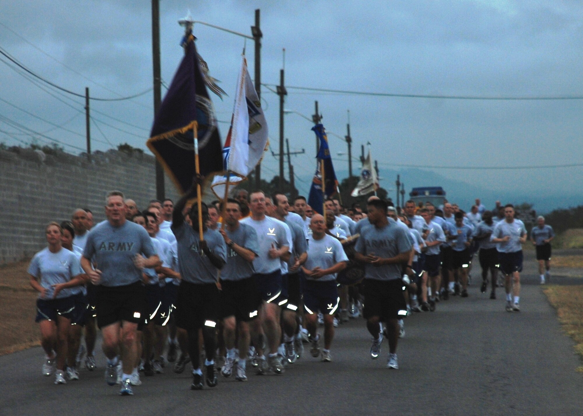 Soldiers, Sailors, Airmen and Marine participate in a morning formation run around Soto Cano Air Base, Honduras, March 4. Army Col. Gregory Reilly, Joint Task Force-Bravo commander, led all of Team Soto Cano in the formation run designed to build unit cohesion and esprit de corps. (U.S. Air Force photo by 1st Lt. Jennifer Richard)