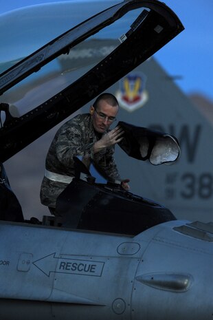 NELLIS AIR FORCE BASE, Nev. -- Airman 1st Class Jeremy Hunt, a crew chief assigned to the 20th Aircraft Maintenance Squadron, Shaw AFB S.C. removes the cover off of a 55th Fighter Squadron F-16's heads up display while preparing the aircraft for a night mission during Red Flag 10-3 Feb 25, 2010.  Red Flag is a realistic combat training exercise involving the air forces of the United States and its allies. The exercise is conducted on the 15,000-square-mile Nevada Test and Training Range, north of Las Vegas.  (U.S. Air Force photo by Tech. Sgt. Michael R. Holzworth/RELEASED)