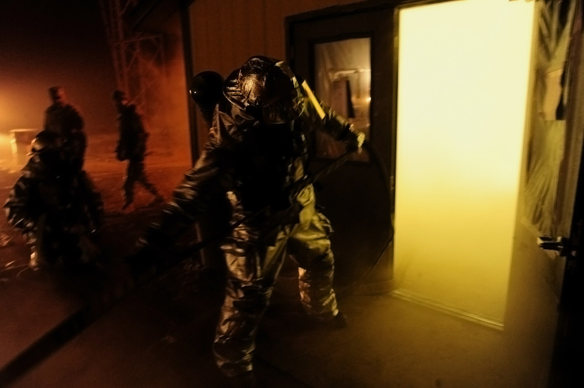 ELLSWORTH AIR FORCE BASE, S.D. -- Senior Airman Cody Simpson, 28th Civil Engineer Squadron firefighter, pulls on a water hose while working with other firefighters to extinguish a simulated fire during a Phase II Operational Readiness Exercise, March 3. During the Phase II ORE, firefighters were tested on their ability to respond to and extinguish fires in a deployed environment. (U.S. Air Force photo/Airman 1st Class Joshua J. Seybert)