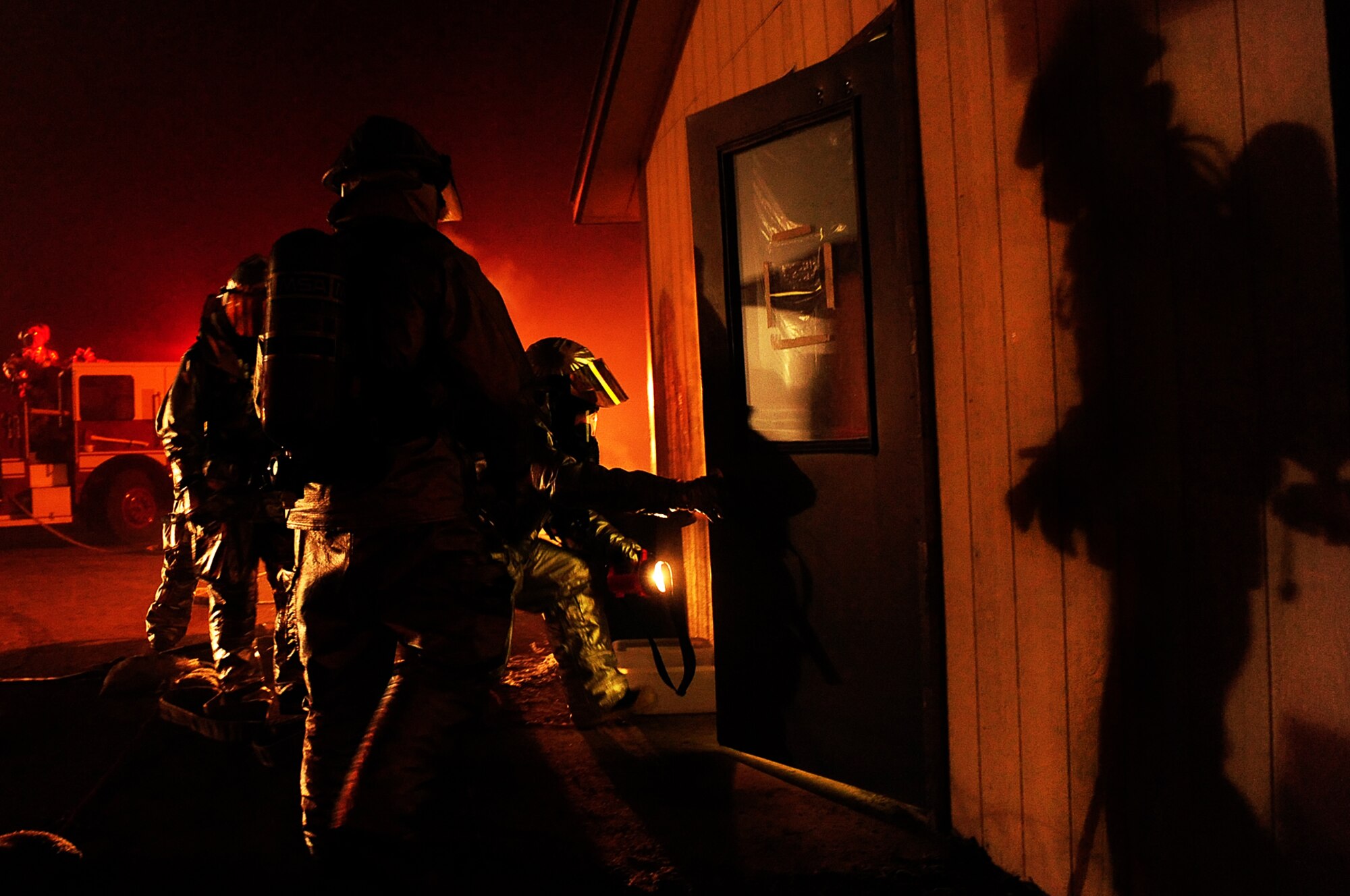 ELLSWORTH AIR FORCE BASE, S.D. -- Members of the 28th Civil Engineer Squadron fire department prepare to extinguish a simulated fire during a Phase II Operational Readiness Exercise, March 3. The Phase II ORE is designed to simulate a deployed environment and test the combat abilities of Ellsworth Airmen. (U.S. Air Force photo/Airman 1st Class Joshua J. Seybert)