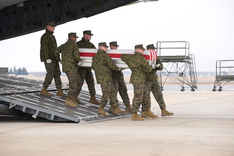 A U.S. Marine Corps team transfers the remains of Marine Corps Lance Cpl. Carlos A. Aragon, of Orem, UT, at Dover Air Force Base, Del., on March 3, 2010. Lance Cpl. Aragon was assigned to  4th Light Armored Reconnaissance Battalion, 4th Marine Division, Marine Forces Reserve based out of Camp Pendleton, Calif. (U.S. Air Force photo/Brianne Zimny)