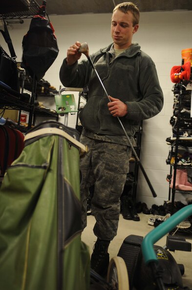 ELLSWORTH AIR FORCE BASE S.D. -- Airman 1st Class Keith Ostrander, 28th Aircraft Maintenance Squadron hydraulics specialist, looks over a golf club at the B-One Yard thrift and consignment shop, Feb. 26. Items such as toys, kitchenware and sports equipment can be found throughout the store for purchase. (U.S. Air Force photo/Airman 1st Class Corey Hook)
