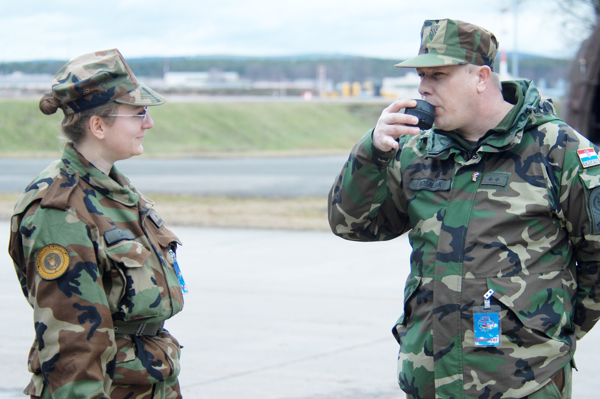Croatian army 2nd Lt. Sabina Sacer and Private 1st Class Stanko Bosnjak take a taste of water they have just purified using a reverse osmosis water purification unit Feb. 24, 2010 at Ramstein Air Base, Germany. (U.S. Air Force photo/Tech. Sgt. Michael Voss)