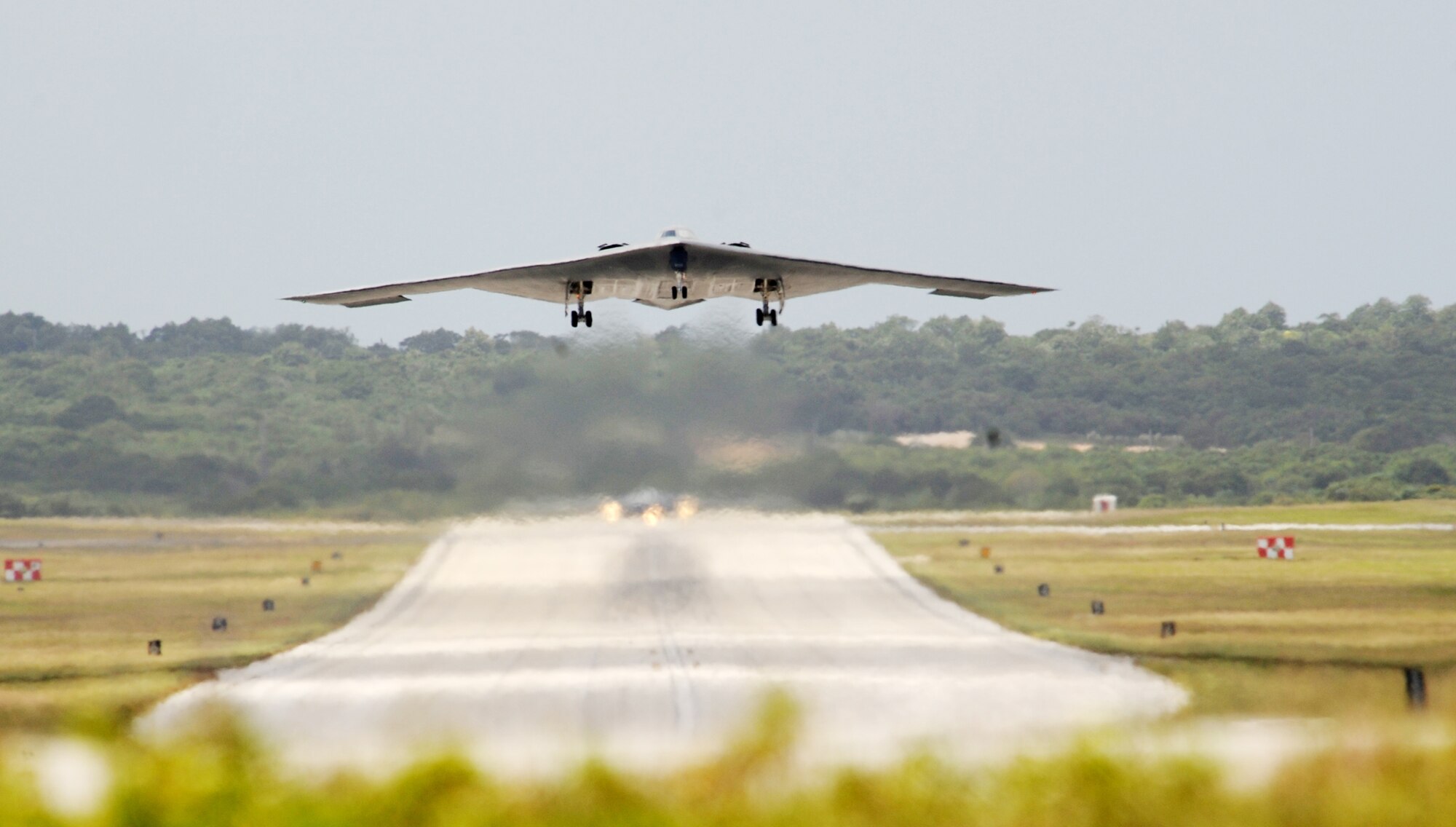 A B-2 Spirit from Whiteman Air Force Base, Mo., gets airborne while another B-2 waits for clearance March 4, 2010, at Andersen Air Force Base, Guam. More than 270 Airmen and four B-2 Spirits are deployed to Andersen AFB supporting the Pacific regions continuous bomber presence. (U.S. Air Force photo/Master Sgt. Kevin J. Gruenwald) 