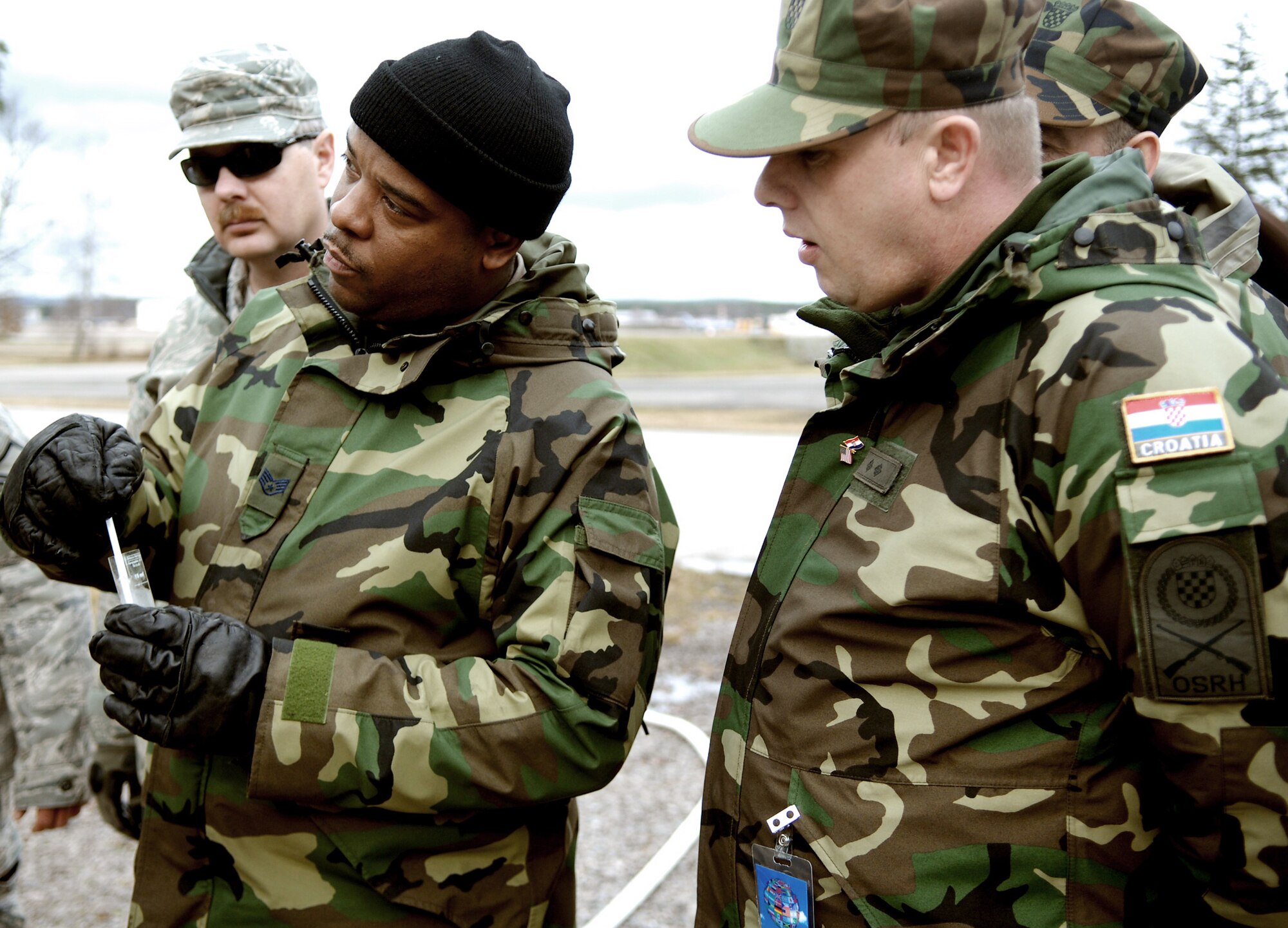 Staff Sgt. Maurice Wakins and Croatia army Private 1st Class Stanko Bosnjak test water they have just purified using a reverse osmosis water purification unit Feb. 24, 2010 at Ramstein Air Base, Germany. Sergeant Wakins is a 94th Civil Engineer Squadron technician from Dobbins Air Reserve Base, Ga. (U.S. Air Force photo/Tech. Sgt. Michael Voss)

