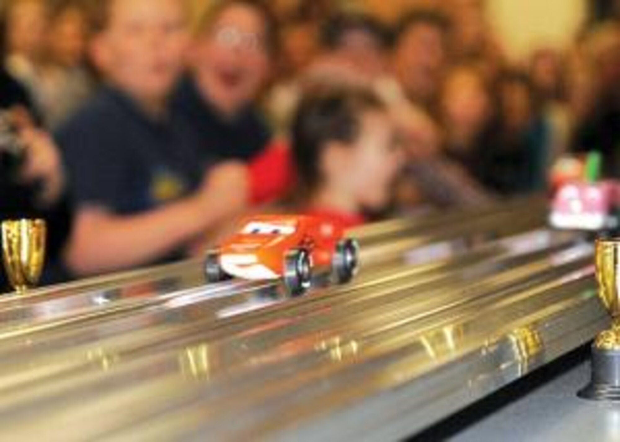 A car races down the "Right Track" at the Base Chapel during the Awana club Grand Prix event March 2. 