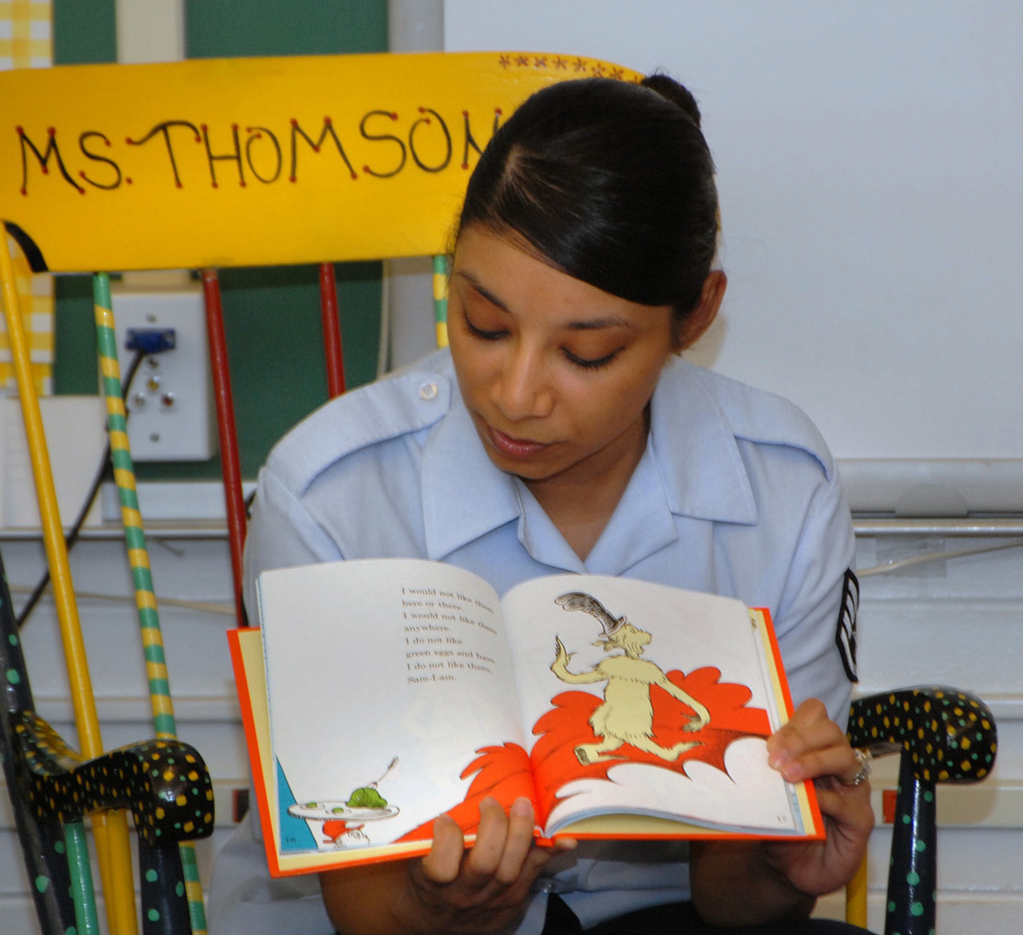 Staff Sgt. Ana Casas, DPA, reads to students at Lyn Knoll Elementary School in Aurora during Read Across America on March 2, the birthday of Dr. Seuss. Sergeant Casas was one of 14 volunteers from the Air Reserve Personnel Center who participated in the annual nationwide event designed to motivate children to read. (U.S. Air Force photo/Dwayne Beuthel)