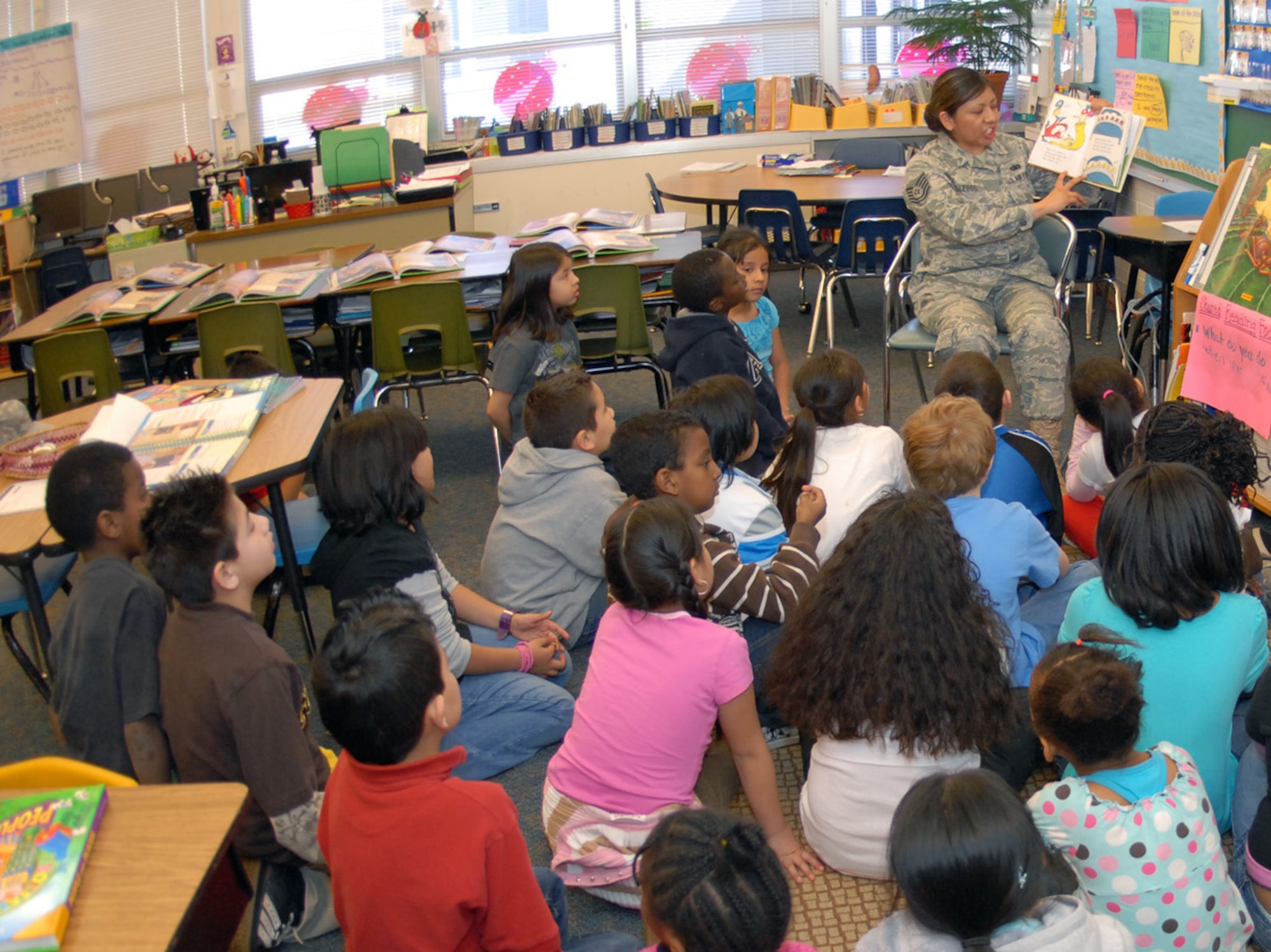 Tech. Sgt. Deann Gallegos, DPS, reads to students at Lyn Knoll Elementary School in Aurora during Read Across America on March 2, the birthday of Dr. Seuss. Sergeant Gallegos was one of 14 volunteers from the Air Reserve Personnel Center who participated in the annual nationwide event designed to motivate children to read. (U.S. Air Force photo/Dwayne Beuthel)