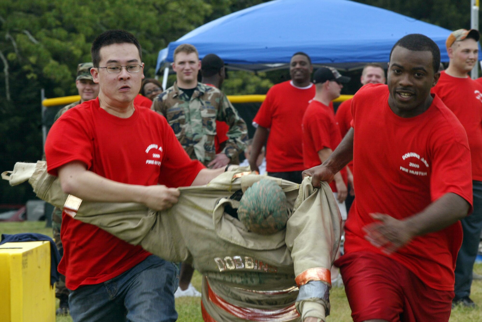 Members compete in a relay race during the Fire Muster competition at Family Day 2009. The Base Fire Department is looking for teams to sign up for the annual competition at Family Day 2010 on Saturday, May 1. To sign up a four-person team, call the Fire Prevention Office at 678-655-5679. 