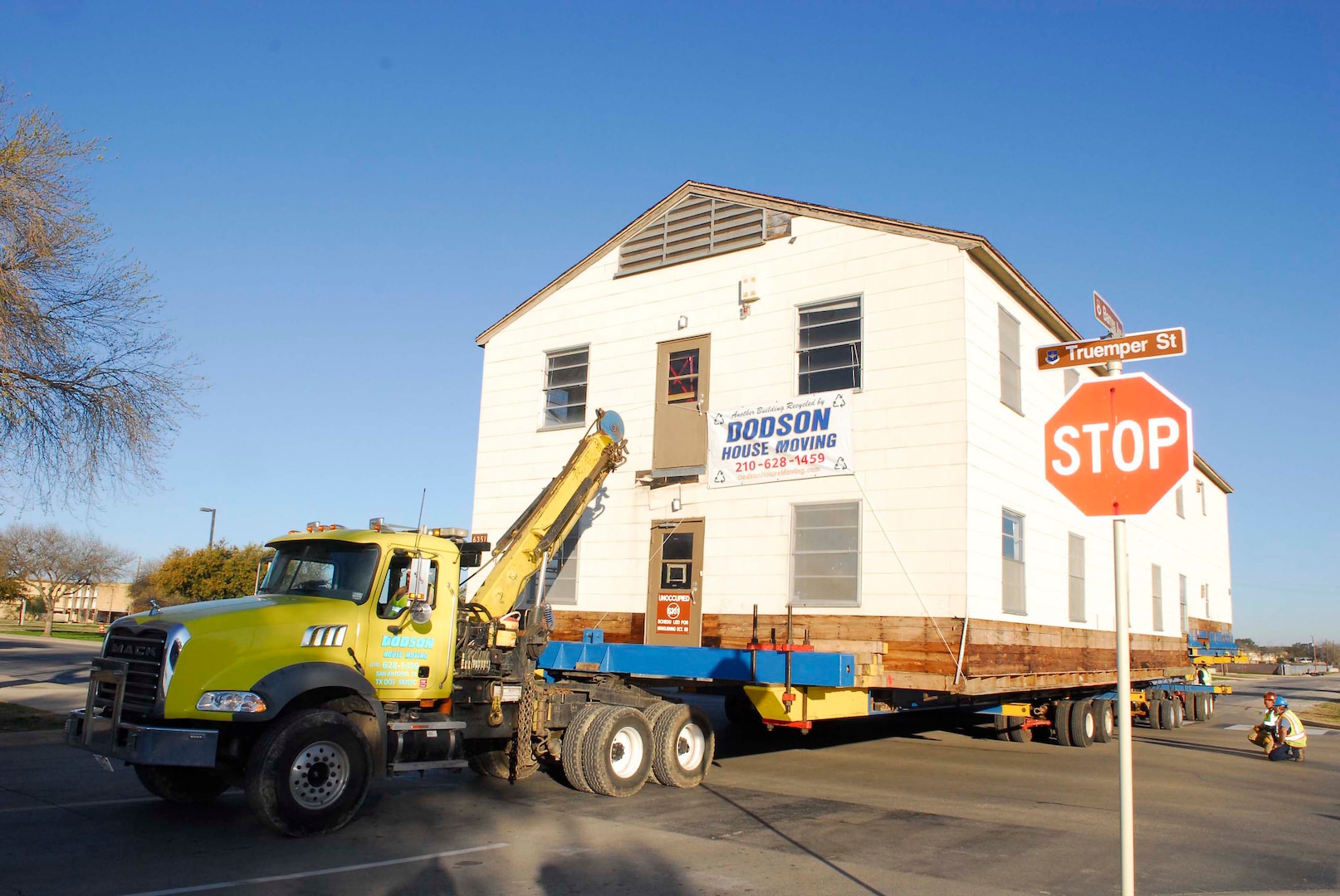 A military open bay dormitory is towed past Truemper Street Feb. 27. The dormitory, moved from the Airman Training Complex construction site to the History and Traditions Museum, will become a part of the museum's enlisted heritage exhibits following renovation and restoration. (U.S. Air Force photo/Alan Boedeker)