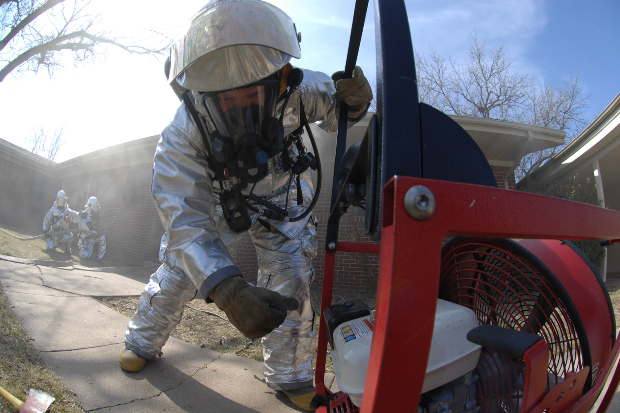Staff Sgt. John Lane, a 22nd Civil Engineer Squadron firefighter, uses a pressurized fan to clear smoke from a simulated burning building during a unit compliance inspection, Feb. 26, 2010, at McConnell Air Force Base, Kan. A major command UCI occurs about every four years at McConnell to evaluate how the 22nd Air Refueling Wing accomplishes its mission. (U.S. Air Force photo/Staff Sgt. Jamie Train)
