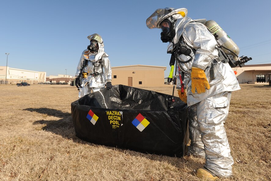 Firemen from the 22nd Civil Engineer Squadron set up a hazardous decontamination pool for victims to wash off contaminates Feb. 24, 2010, during an emergency management inspection exercise at McConnell Air Force Base, Kan. Emergency management teams, which include medical personnel, security forces and firefighters, were inspected on their ability to respond and follow proper protocol during a major emergency as part of the Air Mobility Command unit compliance inspection. (U.S. Air Force photo/Staff Sgt. Jamie Train)