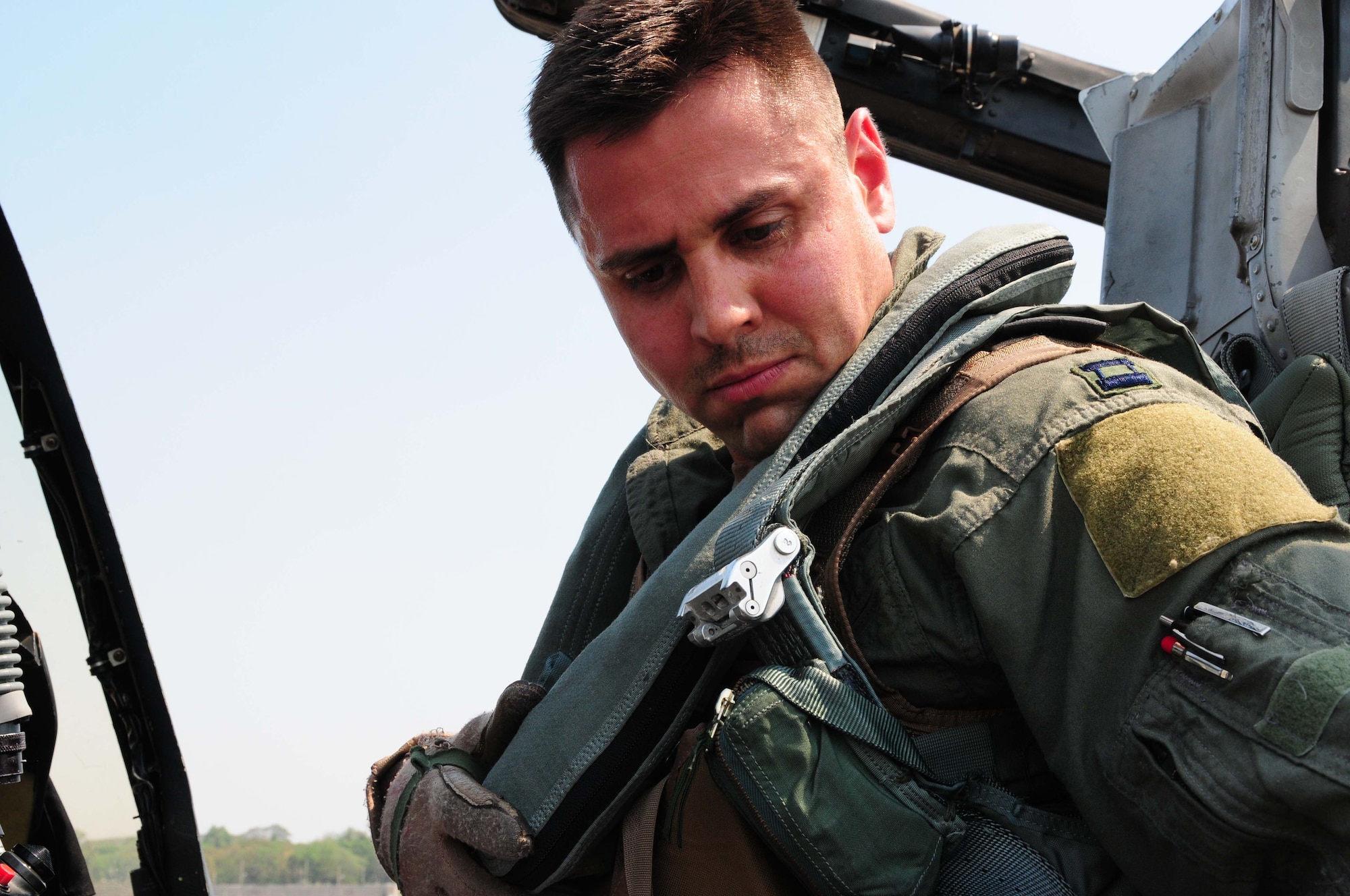 Capt. Matthew Lackey straps in to an A-10 Thunderbolt II prior to flying the first A-10 mission of Cope Tiger 2010 at Udon Thani Royal Thai Air Force Base, Thailand, on March 4. Captain Lackey is deployed to the exercise from the 25th Fighter Squadron at Osan Air Base, South Korea.  His squadron is participating in the annual, multilateral field training exercise involving the U.S. Air Force, Royal Thai Air Force and Army, and the Republic of Singapore Air Force March 1-12.  (U.S. Air Force photo/Capt. Genieve David)