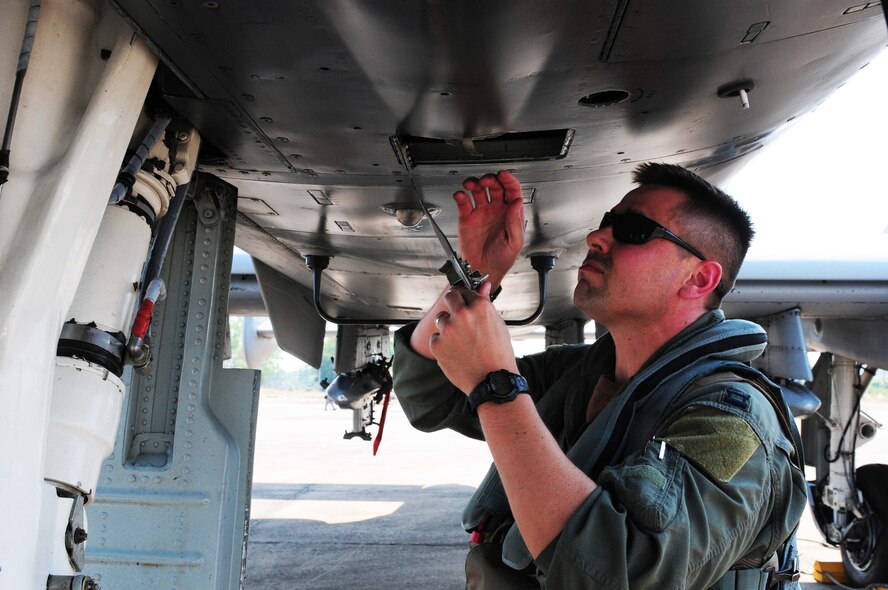 Capt. Matthew Lackey conducts an exterior inspection of an A-10 Thunderbolt II prior to flying the first A-10 mission of Cope Tiger 2010 at Udon Thani Royal Thai Air Force Base, Thailand, on March 4. Captain Lackey is deployed to the exercise from the 25th Fighter Squadron at Osan Air Base, South Korea.  His squadron is participating in the annual, multilateral field training exercise involving the U.S. Air Force, Royal Thai Air Force and Army, and the Republic of Singapore Air Force March 1-12.  (U.S. Air Force photo/Capt. Genieve David)