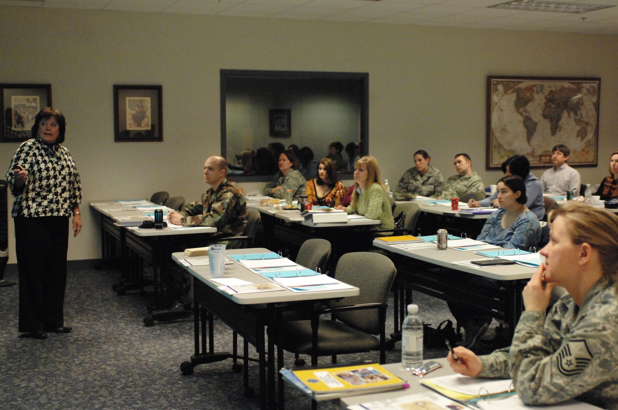Maria Turain, a military spouse and experience teacher, talks with parents at the second parent workshop held at the Airman & Family Readiness Center March 4, 2010.  The parent workshops train and provide tools to help military parents become better advocates for their children while transferring from school to school because of military relocation.