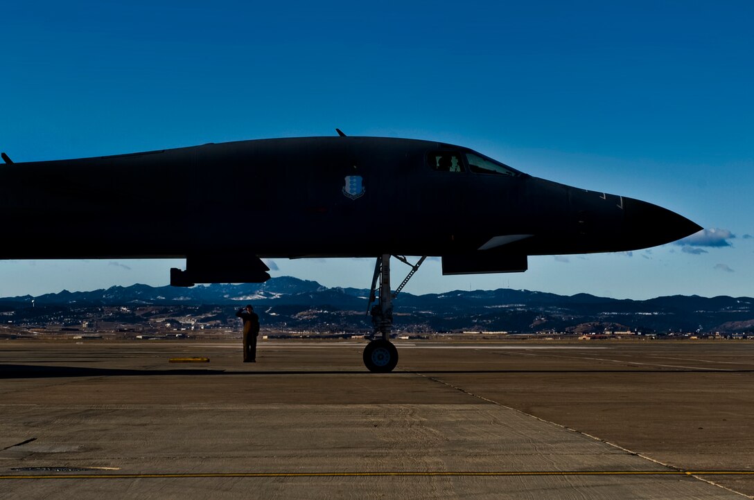 ELLSWORTH AIR FORCE BASE, S.D. -- Col. Kory Cornum, Air Combat Command's command surgeon climbs a ladder to a B-1B Lancer before a flight, Feb. 26. The purpose of Colonel Cornum's visit was to present the ACC level Air Force Medical Awards to winners from the 28th Medical Group. (U.S. Air Force photo/Airman 1st Class Joshua J. Seybert)