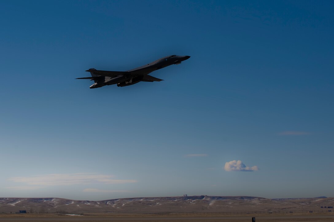 ELLSWORTH AIR FORCE BASE, S.D. -- Airman 1st Class Matthew Mcfarlan, 28th Aircraft Maintenance Squadron crewchief, talks with a maintainer inside a B-1B Lancer during a pre-flight inspection, Feb. 26. Inspections are performed to ensure aircraft systems are working properly and ready for flight. (Air Force photo/Airman 1st Class Joshua J. Seybert)