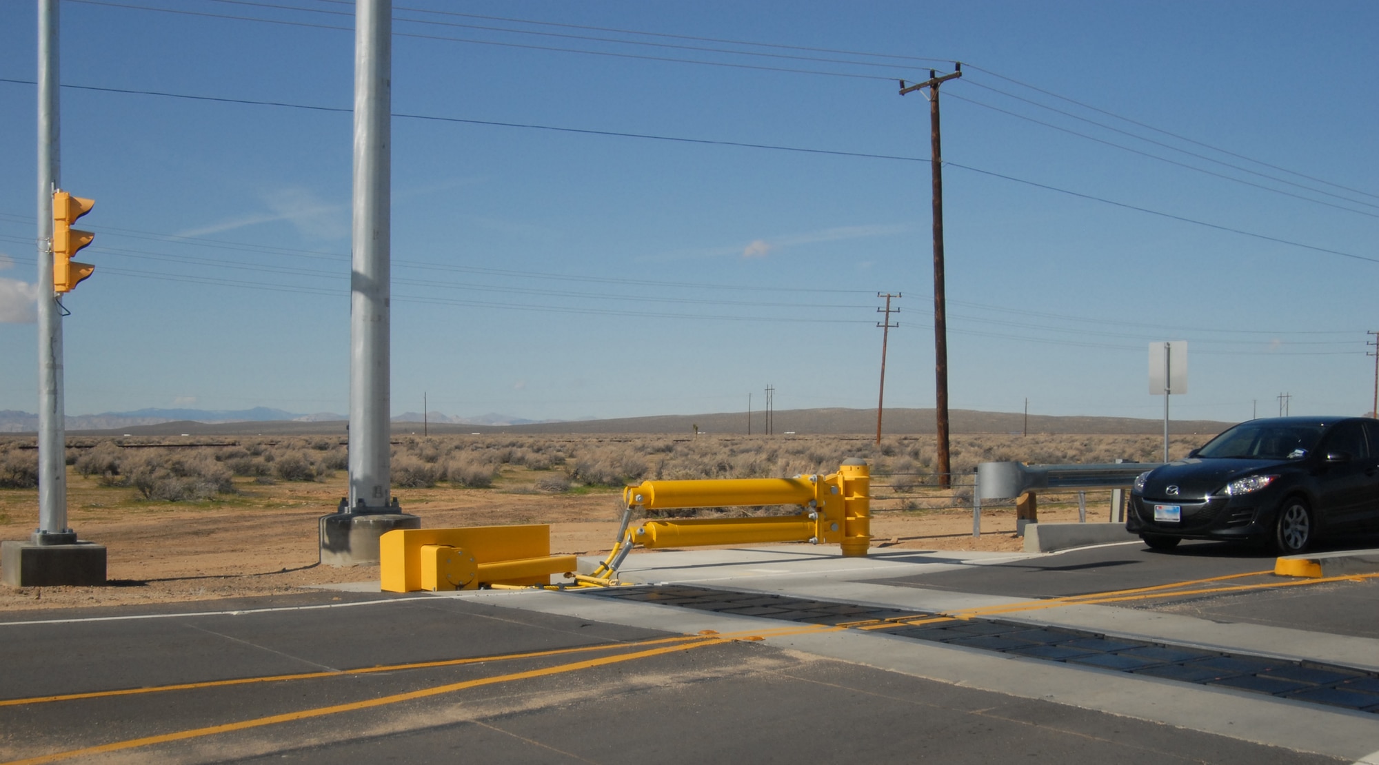 A car approaches the base's new Final Denial Barrier System at the North Gate, which will be employed at the North and South Gates March 5 and construction on the West Gate is currently underway with completeion scheduled for October. (Air Force photo/Stephen K. Robinson)