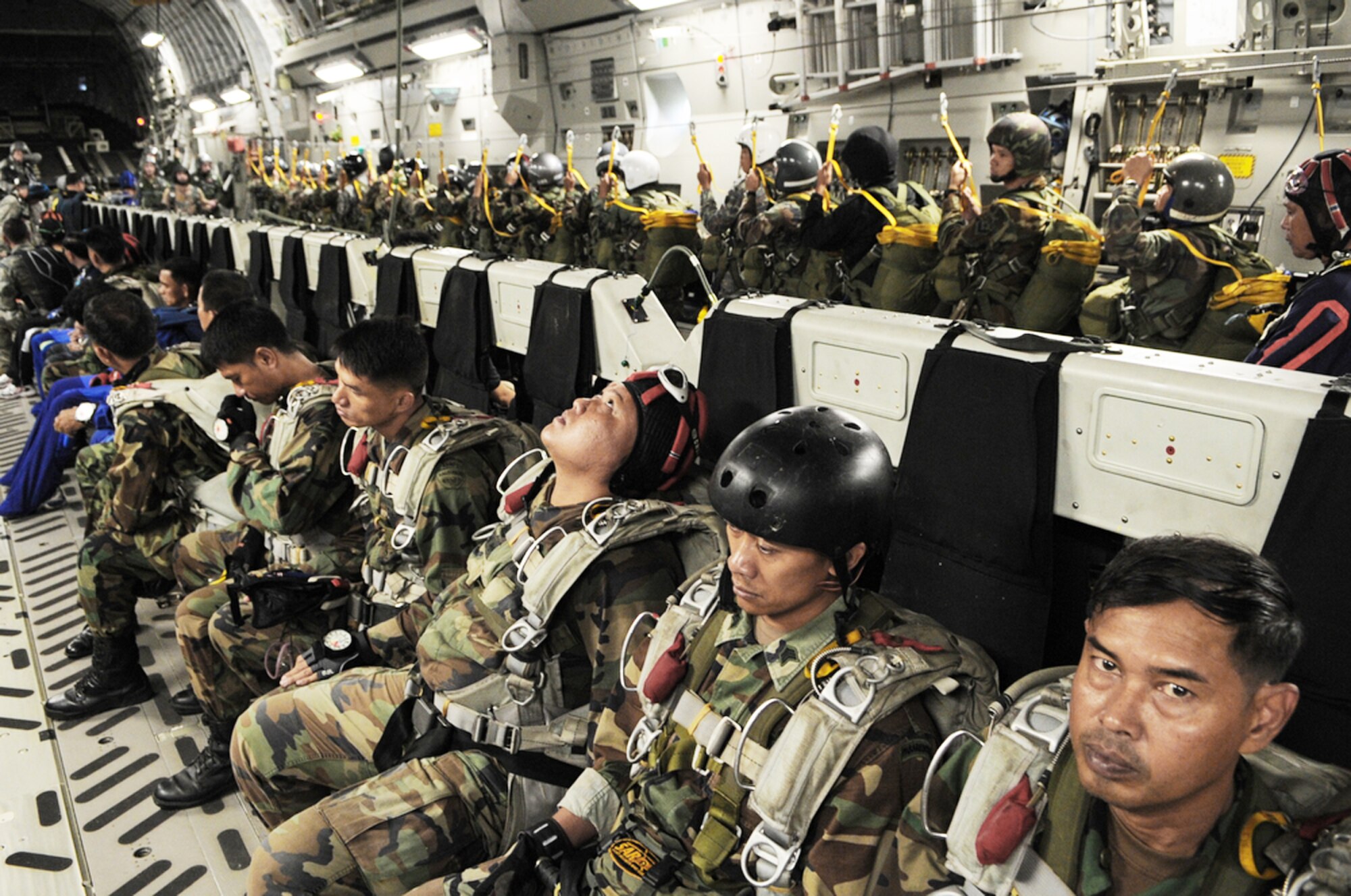 Members of the Royal Thai Air Force parachute team standby for a 10,000-foot static-line jump from a C-17 Globemaster III during Cope Tiger 2010 March 3, 2010 at Dom Muang Royal Thai Air Force Base, Thailand. (U.S. Air Force photo/Tech. Sgt. Cohen A. Young)