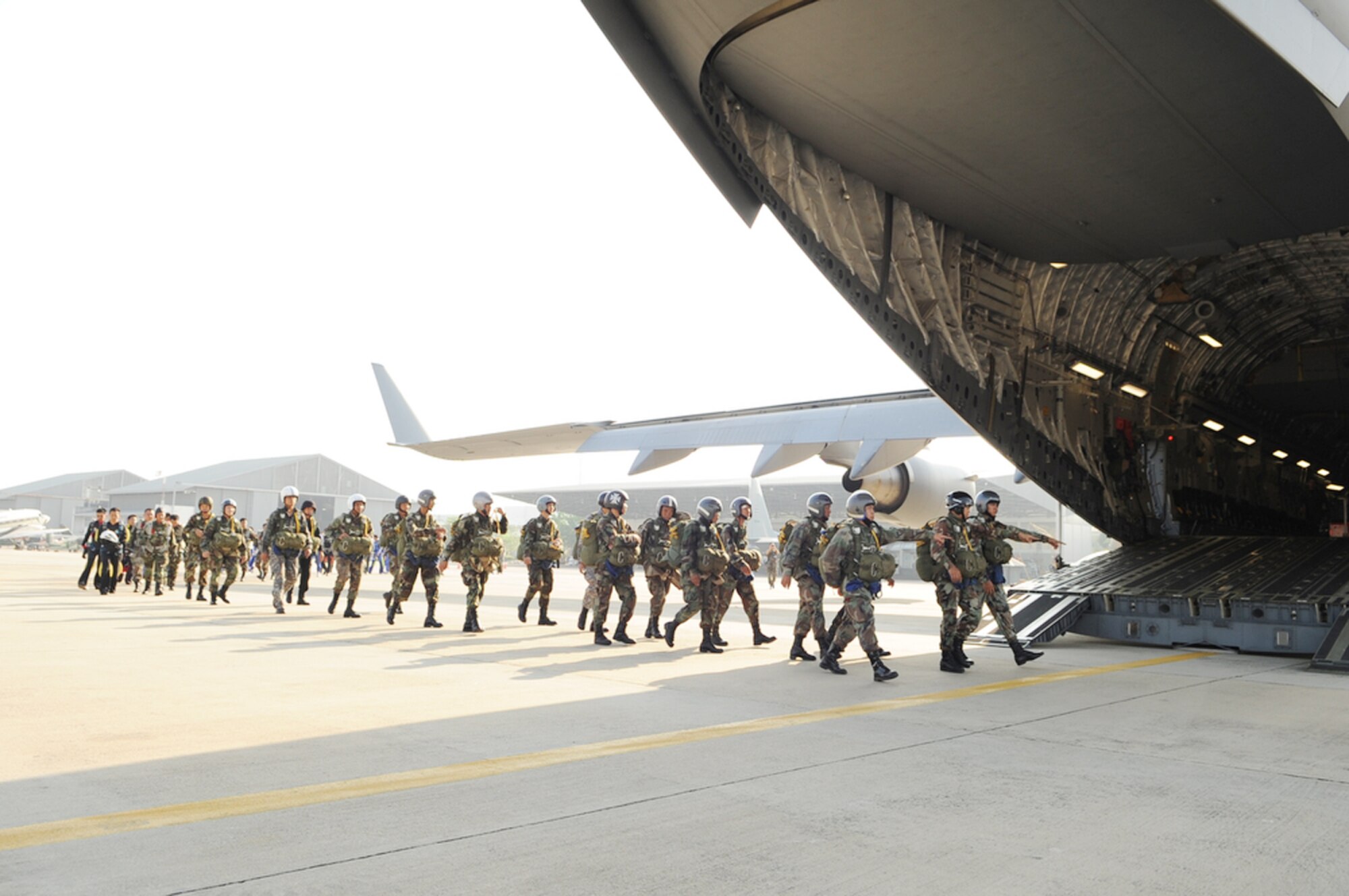 Members of the Royal Thai Air Force parachute team prepare to board a U.S. Air Force C-17 Globemaster III from the 535th Airlift Squadron at Joint Base Pearl Harbor-Hickam, Hawaii, March 3, 2010, during Cope Tiger 2010 at Dom Muang Royal Thai Air Force Base, Thailand. (U.S. Air Force photo/Tech. Sgt. Cohen A. Young)