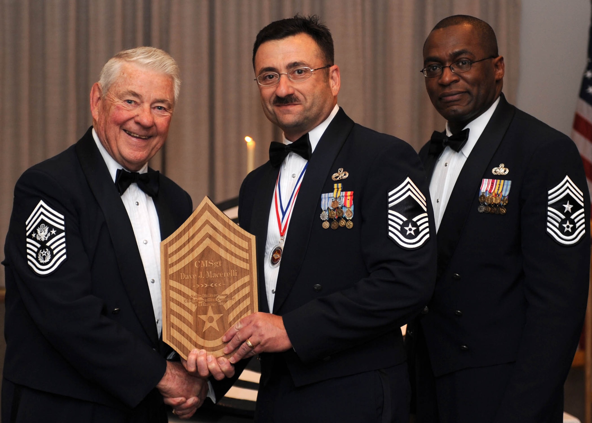 Chief Master Sergeant Macerelli, 926th Group maintenance superintendent (center), is presented with a memento by Chief Master Sergeant (retired) Robert D. Gaylor (left), and 99th Air Base Wing Command Chief Master Sergeant Alfred Herring during the Chief Master Sergeant Recognition ceremony Feb. 26. Chief Macerelli is the 926th GP's newest senior non-commissioned officer to join the top one percent of the enlisted force promoted to the rank of chief. (U.S. Air Force photo/Staff Sgt. Erin Worley)
