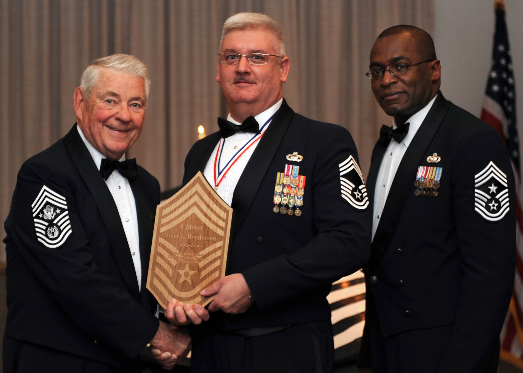 Chief Master Sergeant Steven Henderson, 78th Reconnaissance Squadron superintendent (center), is presented with a memento by Chief Master Sergeant (retired) Robert D. Gaylor (left), and 99th Air Base Wing Command Chief Master Sergeant Alfred Herring during the Chief Master Sergeant Recognition ceremony Feb. 26. Chief Henderson is the 78th RS' newest senior non-commissioned officer to join the top one percent of the enlisted force promoted to the rank of chief. (U.S. Air Force photo/Staff Sgt. Erin Worley)
