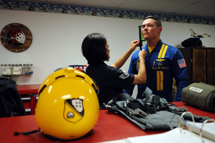 Members of the Navy’s Flight Demonstration Squadron, the Blue Angels, traded in their blue and gold F/A-18 Hornets to strap into an U.S. Air Force red, white and blue Thunderbird F-16 Fighting Falcon here, today