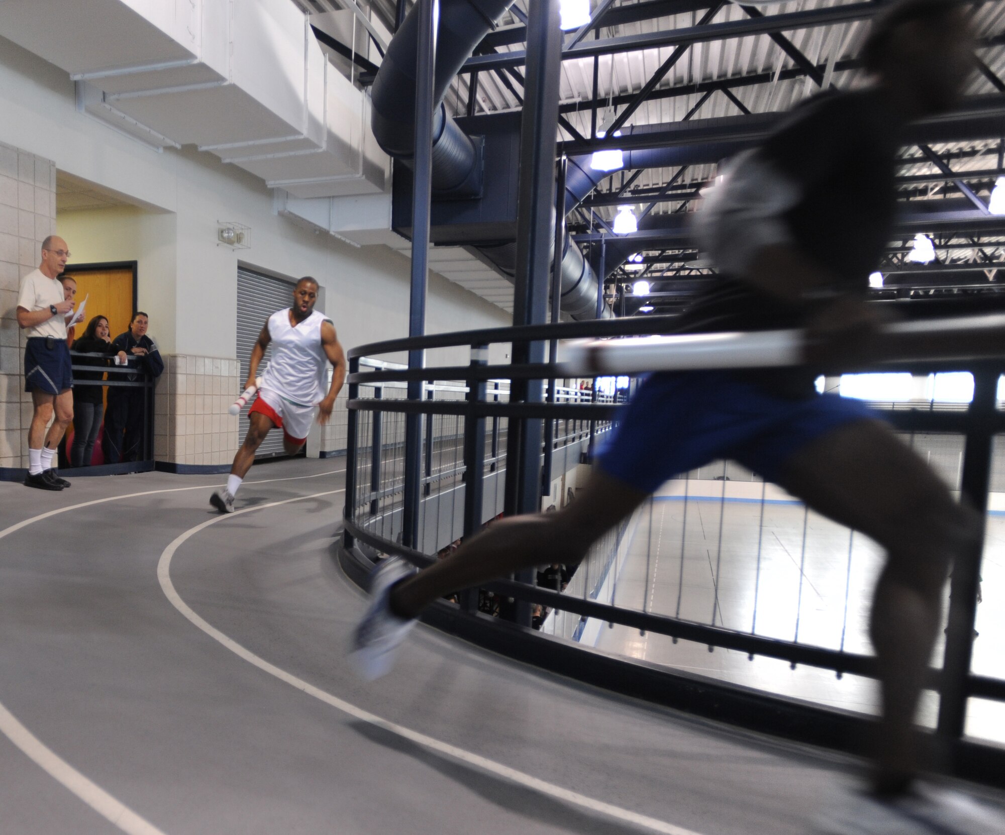 Senior Airman  Maurice Brown, 319th Medical Group, runs the first leg of a five-man relay with the fighting sticks against the 319th Security Forces Squadron Feb. 25 at the Grand Forks Air Force Base, N.D., Fitness Center during the 2010 Winter Bash. The Winter Bash was created to increase esprit-de-corps and allow Airmen to take a break from their day to day work environments. The wing also holds a Summer Bash in August. (U.S. Air Force photo by Staff Sgt. Suellyn F. Nuckolls)