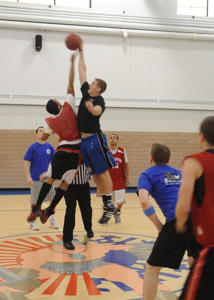 Airman 1st Class Anthony Cole (left), 319th Force Support Squadron, and Capt. Dustin Torbensen,  905th Air Refueling Squadron, jump for the ball Feb. 25 at the Grand Forks Air Force Base, N.D., Fitness Center during a basketball game at the 2010 Winter Bash. The Winter Bash was created to increase esprit-de-corps and allow Airmen to take a break from their day to day work environments. The wing also holds a Summer Bash in August. (U.S. Air Force photo by Staff Sgt. Suellyn F. Nuckolls)