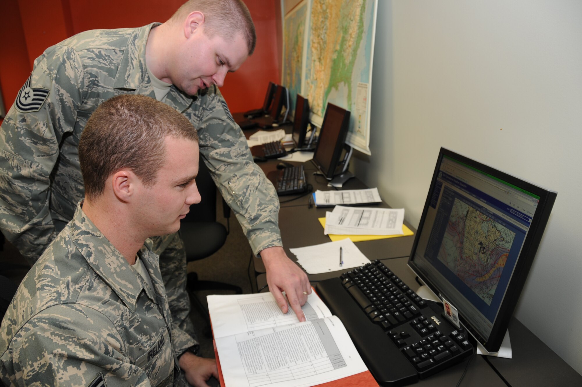Staff Sgt. Sean Ireland, front, a combat weather student, learns about writing forecasts from his instructor, Tech. Sgt. Chris Gates.  (U.S. Air Force photo by Kemberly Groue)