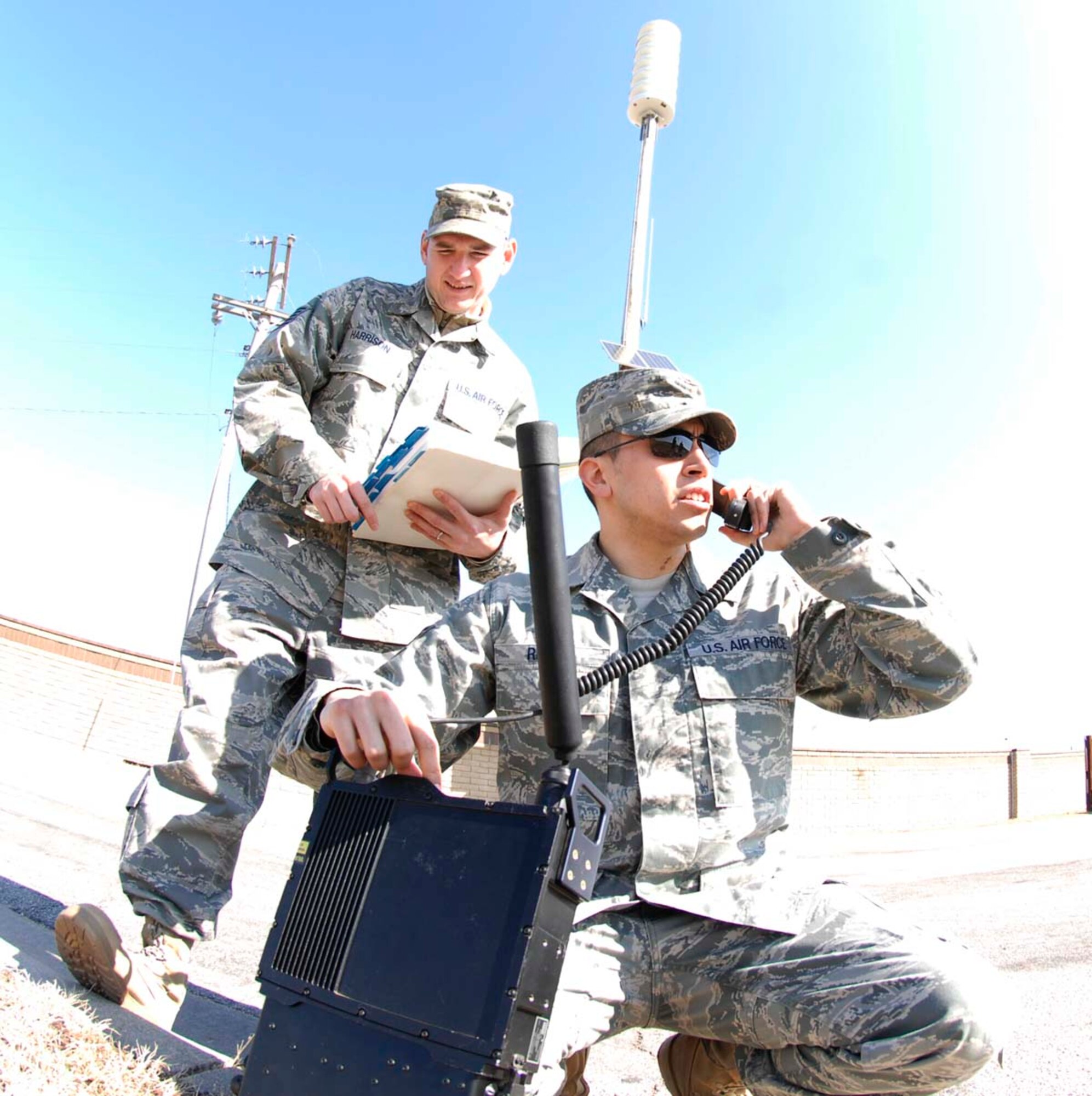 U.S. Air Force Tech. Sgt. Kenneth Harrison, 22nd Communications Squadron NCOIC transmission systems, observes as U.S. Air Force Staff Sgt. Brandon Reyes, 22nd CS transmission systems supervisor, performs an operational sound check on URC-200 radio March 2, 2010, at McConnell Air Force Base, Kans. The radios are used to provide communication between base agencies in contingency operations. (U.S. Air Force photo/Senior Airman Abigail Klein)