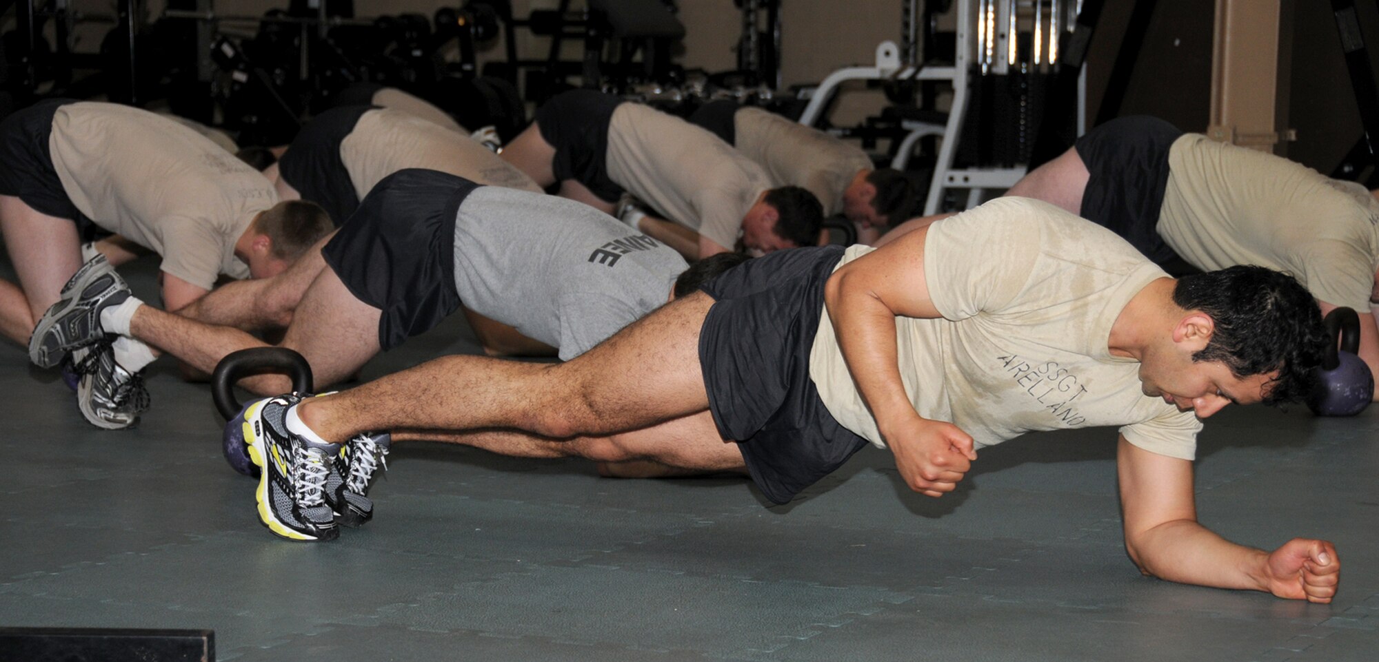 Staff Sgt. Jorge Arellano, a combat weather student in the 335th TRS, goes through physical training with combat control students from the 334th TRS Feb. 25 in Matero Hall.  (U.S. Air Force photo by Kemberly Groue)