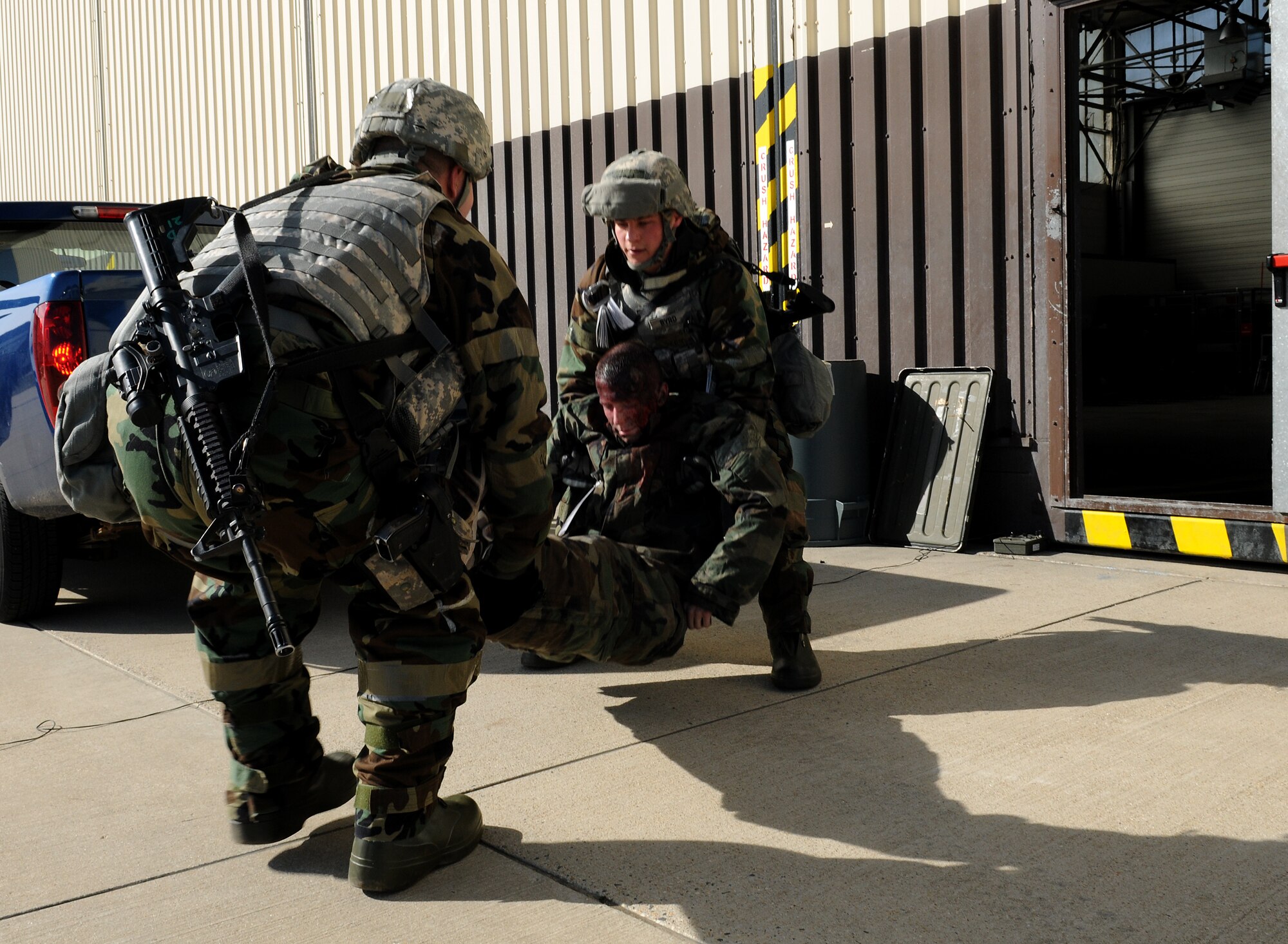 SPANGDAHLEM AIR BASE, Germany – 52nd Security Forces Squadron Airmen lift a simulated casualty for transport to the casualty collection point during Operation Saber Crown 10-04 here March 3. Members of the 52nd Fighter Wing participated in the Phase II exercise to evaluate the wing’s ability to operate in a chemical, biological, radiological, nuclear and explosive environment and to prepare the wing for the NATO force evaluation this summer. (U.S. Air Force photo/Senior Airman Nathanael Callon)